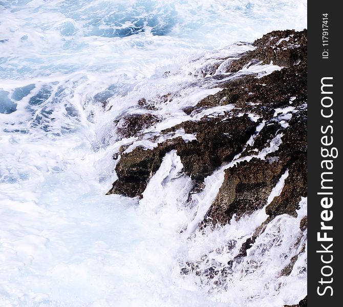 Ocean Waves Crashing on Rock Formation