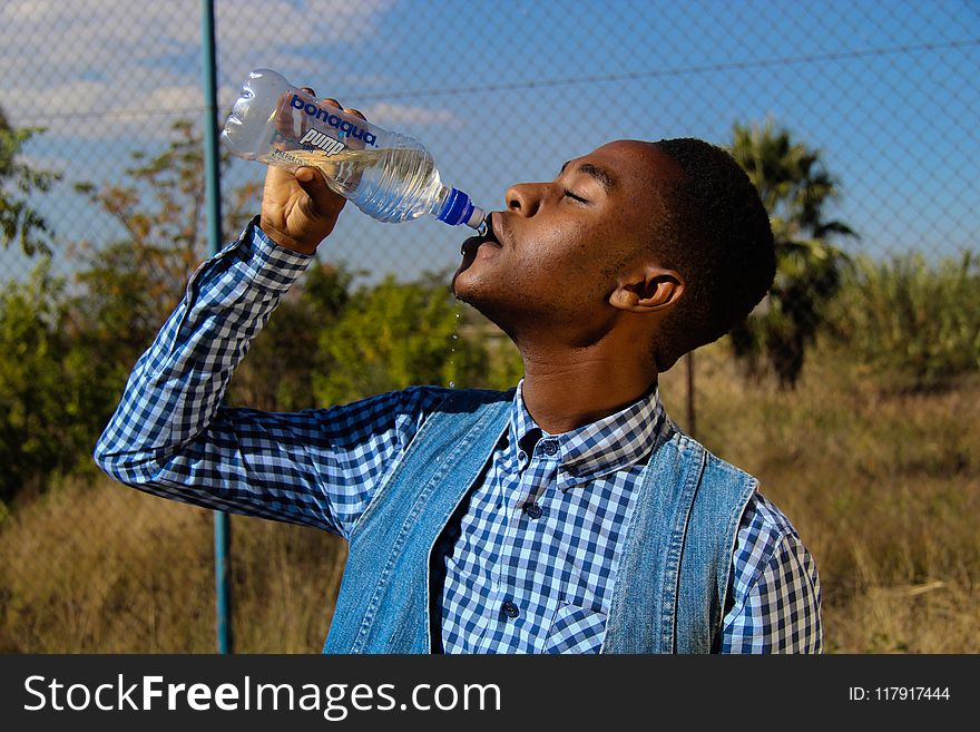 Photography of A Man Drinking Water