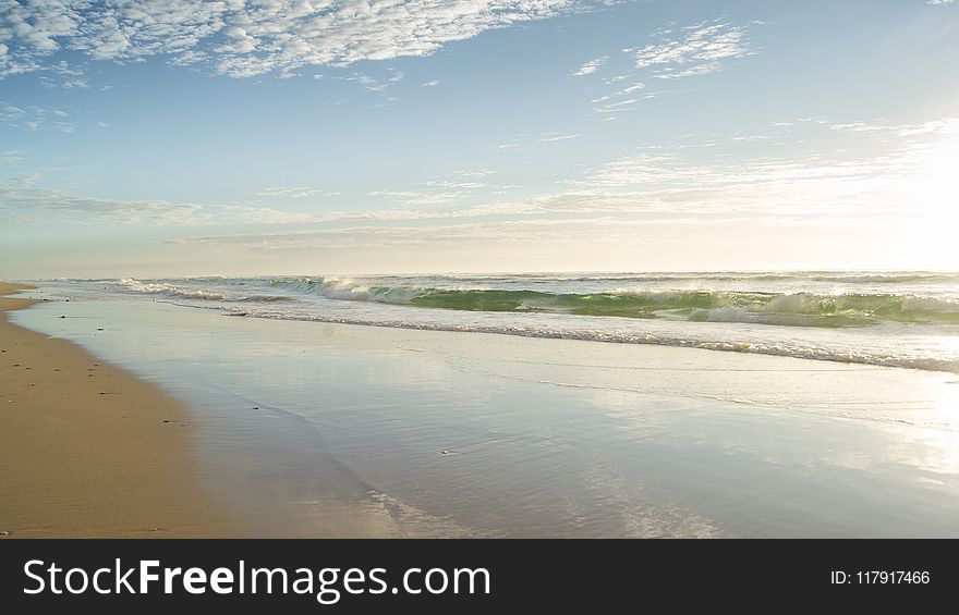 Seashore Under Clear Blue Sky