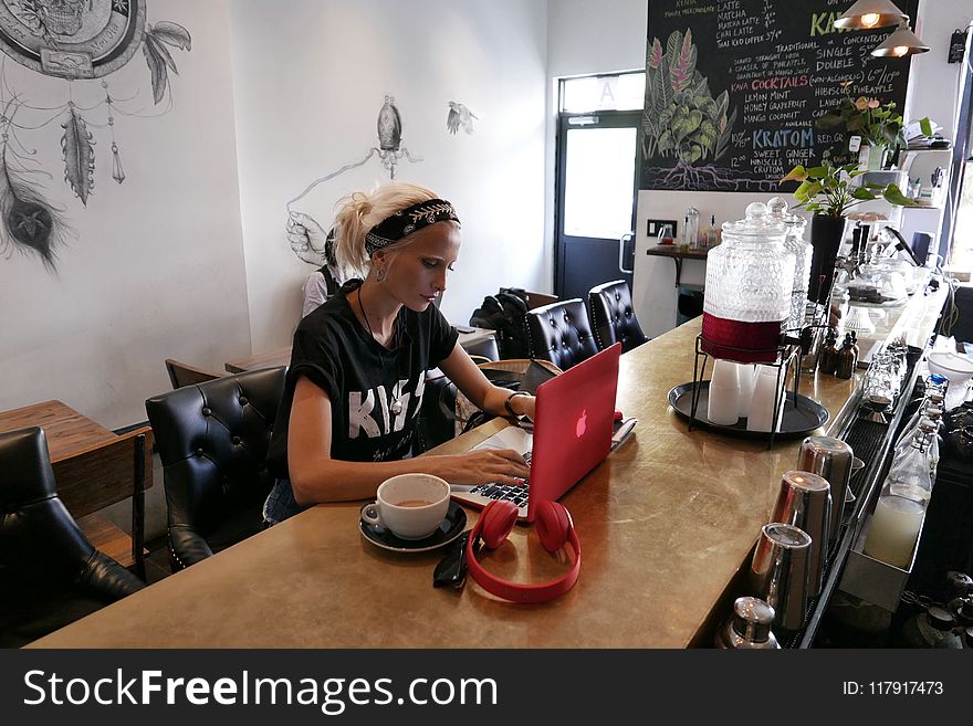 Woman Wears Black Kiss Print Crew-neck Shirts Sits