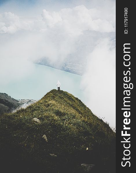 Person Standing on Green Grass Mountain