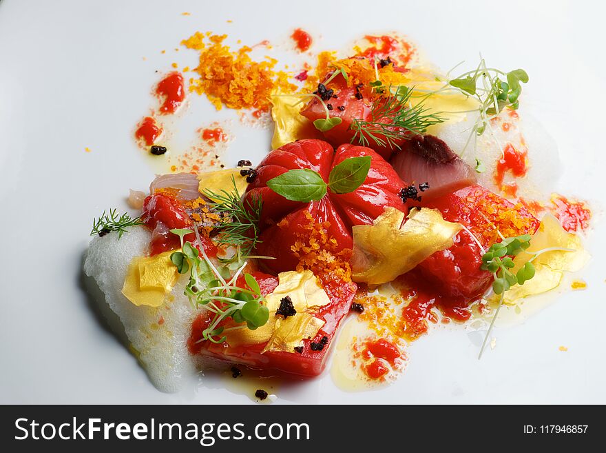 Tomato salad with fish and gold leaf. Tomato salad with fish and gold leaf.