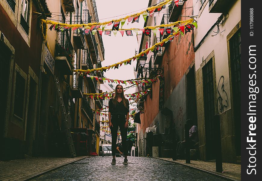 Woman Standing in Middle of Street With Bantings