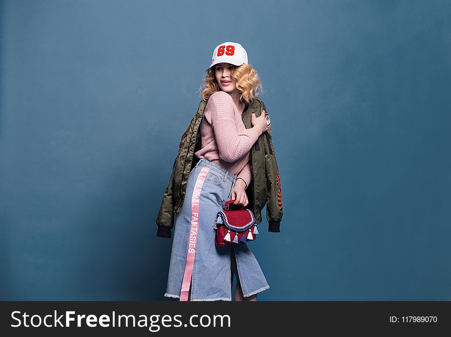 Woman in Pink Sweater and Denim Skirt