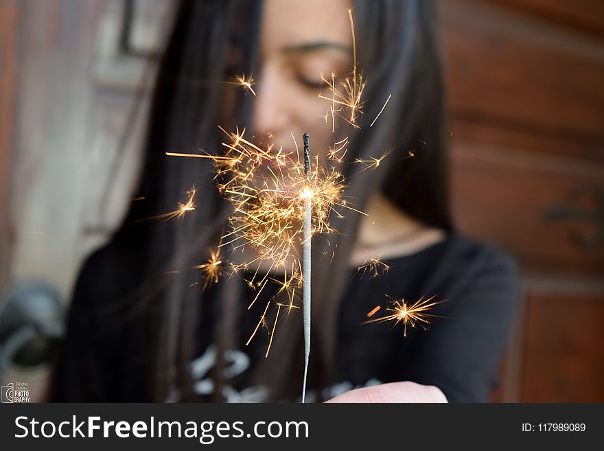Selective Focus Photo Of Person Holding Sparkler