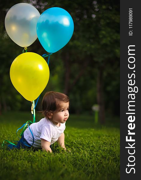 Baby Wearing White Shirt Tied With Three Balloons