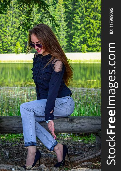Woman Wearing Black Cold-shoulder Top and Blue Denim Jeans