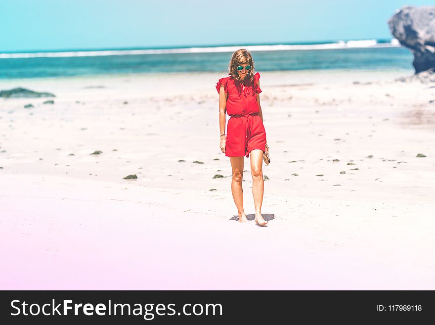 Woman Wearing Red Romper on Beach