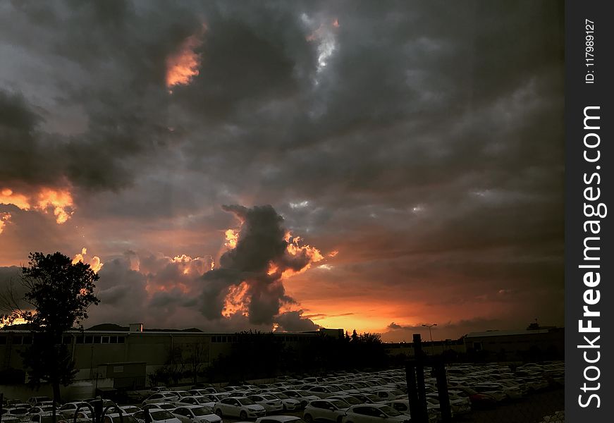 Cars Parked Near Building During Sunset