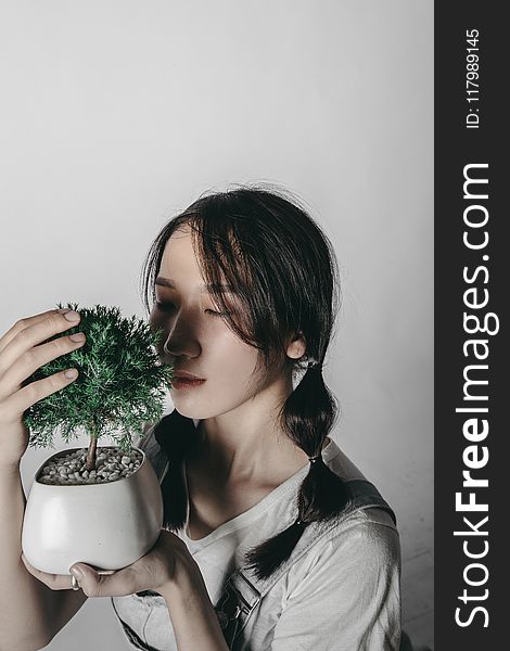 Woman Holding Bonzai Tree