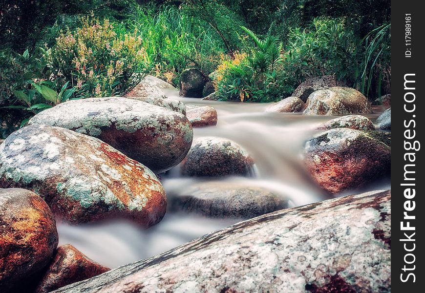 Time Lapse Photo of River Flowing on Rocks