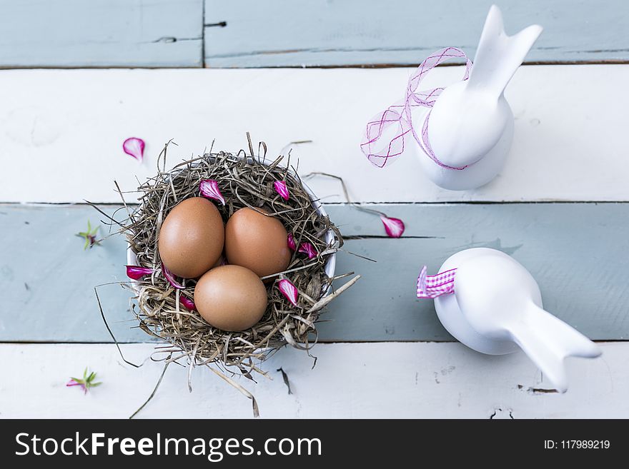 Three Brown Eggs On Nest