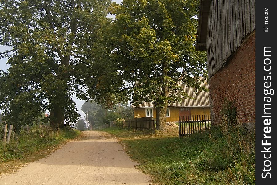 Farm road with old buildings. Farm road with old buildings