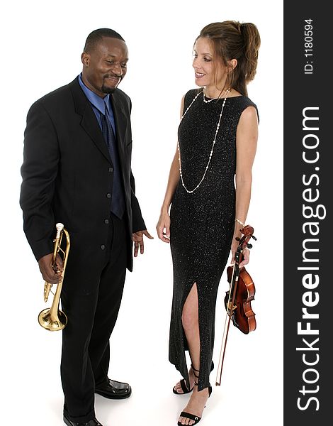 Two musicians, a woman on violin and a man on trumpet, playing around backstage holding their instruments before a concert. Two musicians, a woman on violin and a man on trumpet, playing around backstage holding their instruments before a concert.