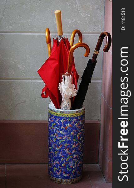 Umbrellas in a colourful container. Umbrellas in a colourful container