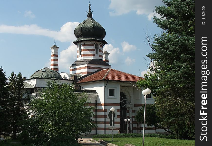 Beautiful old church in the bulgarian town of pleven on blue sky with white clouds
