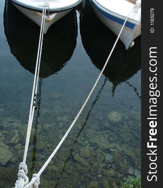 Parked boat pairs and reflections in sea. Parked boat pairs and reflections in sea