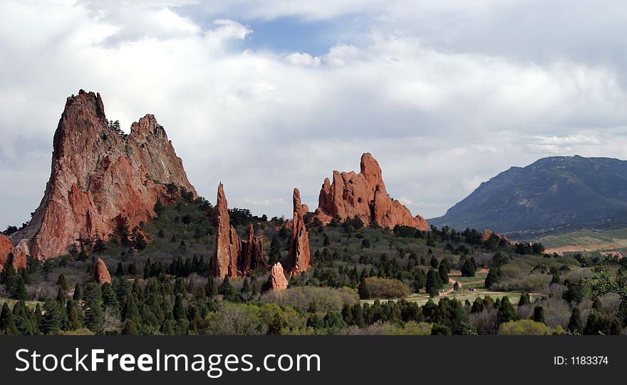 Red mountain spires with a mountainous background in garden of the gods. Red mountain spires with a mountainous background in garden of the gods