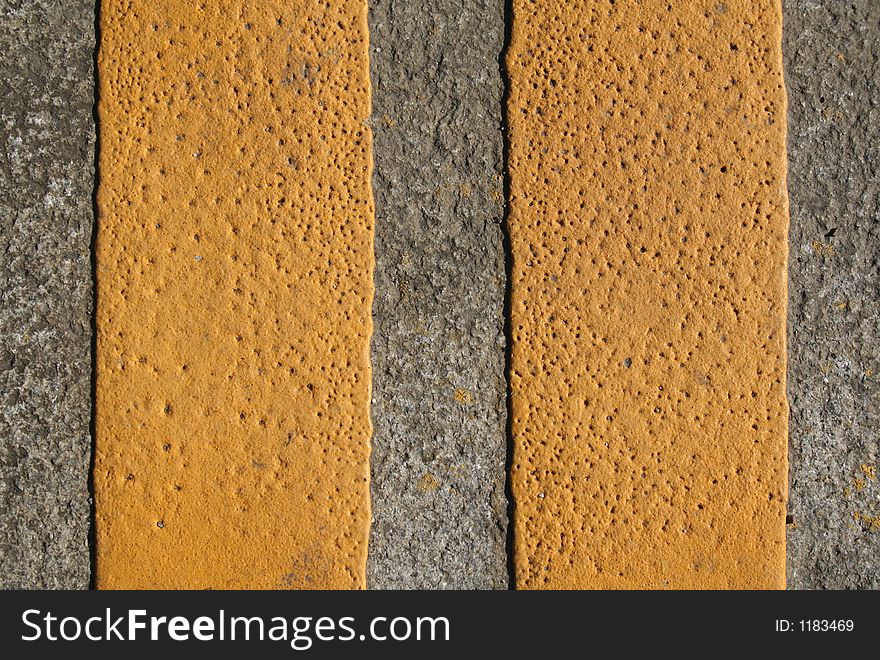 An abstract series with yellow paint on the grey pavement. An abstract series with yellow paint on the grey pavement