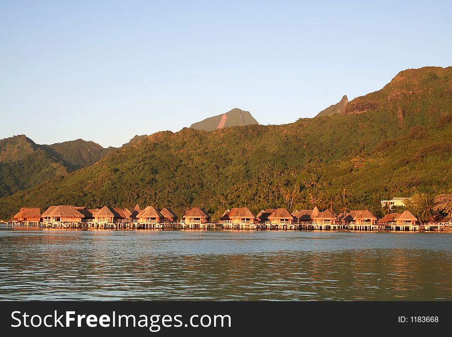 Tropical hotel bungalows at sunrise