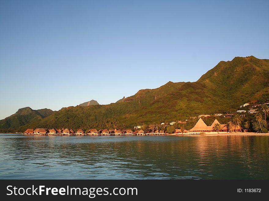 Tropical ressort at sunrise, with overwater bungalows