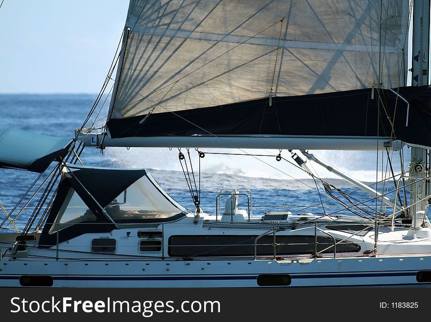 Modern sailboat with a whale splash in the background. Modern sailboat with a whale splash in the background