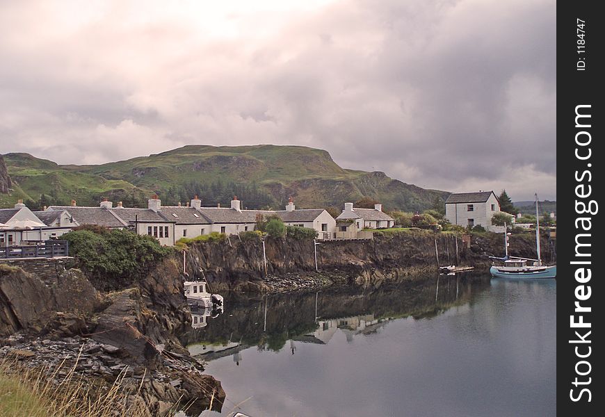 Scottish village reflected in the sea close to Oban on the west coast of Scotland. Scottish village reflected in the sea close to Oban on the west coast of Scotland