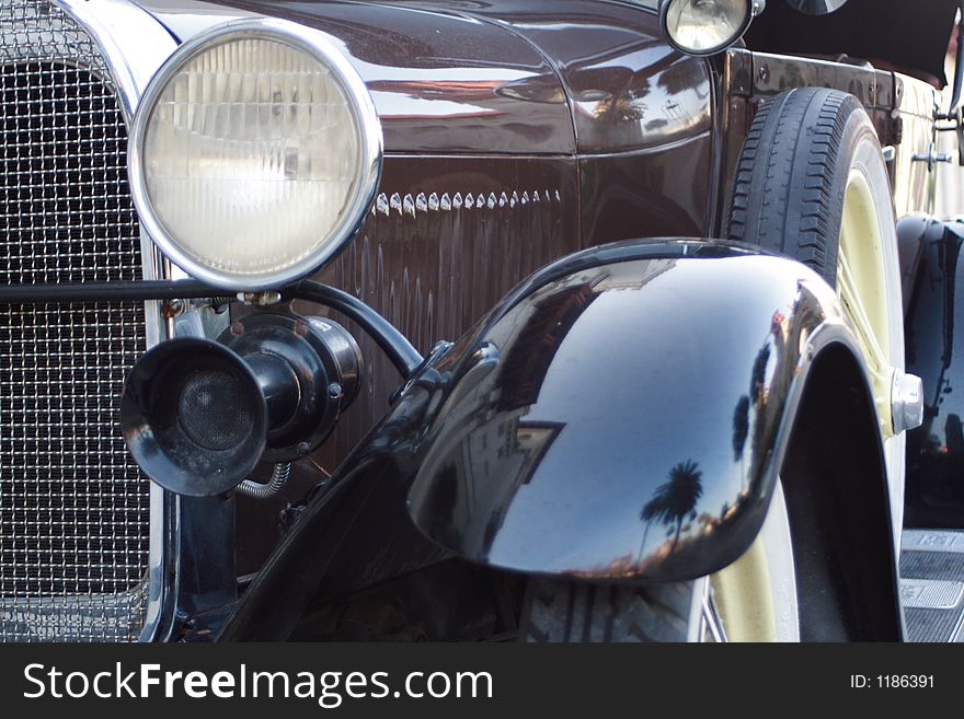 Close up of a shiny, black antique car.