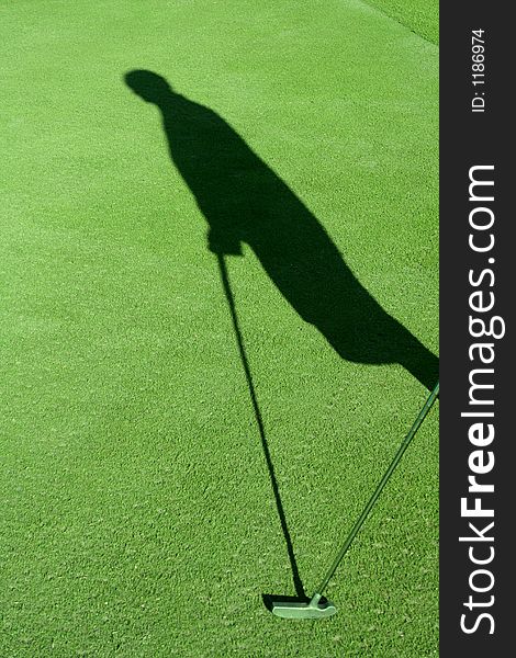 Picture of a shadow of a golfer with club. Picture of a shadow of a golfer with club