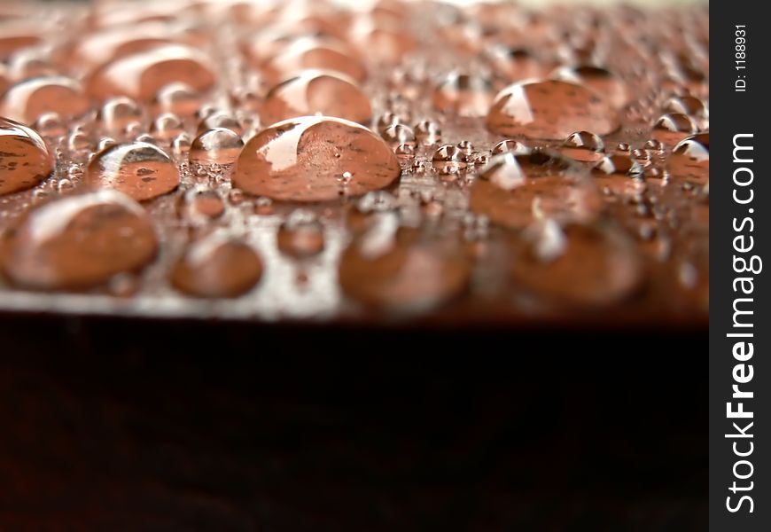 Photo of raindrops beading on a water proofed deck. Photo of raindrops beading on a water proofed deck