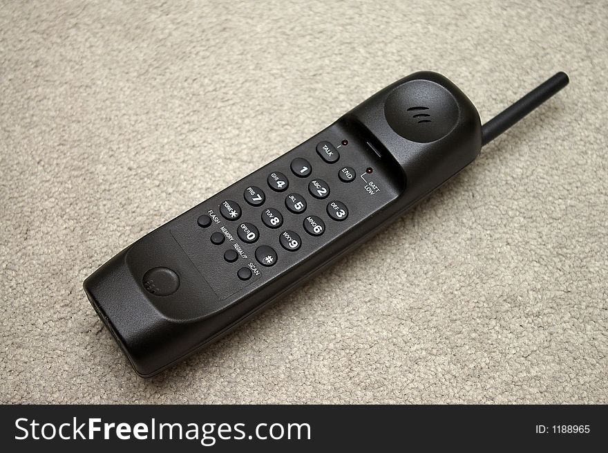 A black cordless telephone handset. A black cordless telephone handset