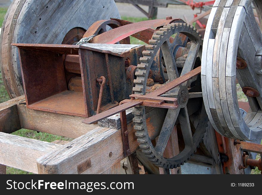 Photo of antique machine showing the gears and moving parts.