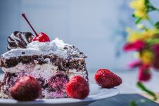 Slice Of Cake With Cherries And Strawberries Stock Photo