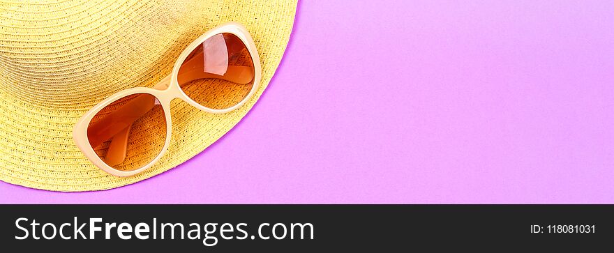 Hat, Sunglasses On A Pastel Pink, Purple Background.