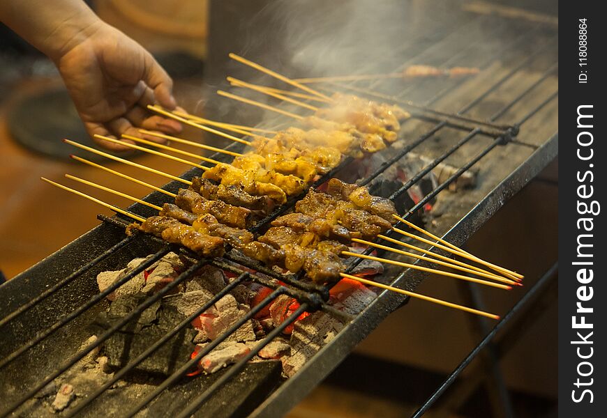 Asian street Food. People cooking, selling and buying Exotic Asian Food