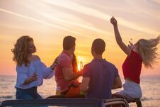 Five Young People Having Fun In Convertible Car At The Beach At Stock Photo