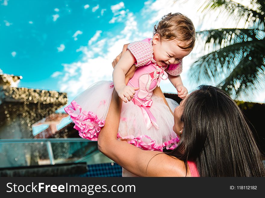 Woman Holding Baby Above Head