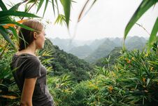 A Female Traveler Stands Among The Jungle And Admires The Breathtaking Scenery Royalty Free Stock Photos