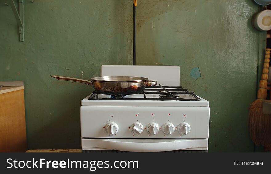 Steel pan on a gas stove in an old kitchen of a communal flat