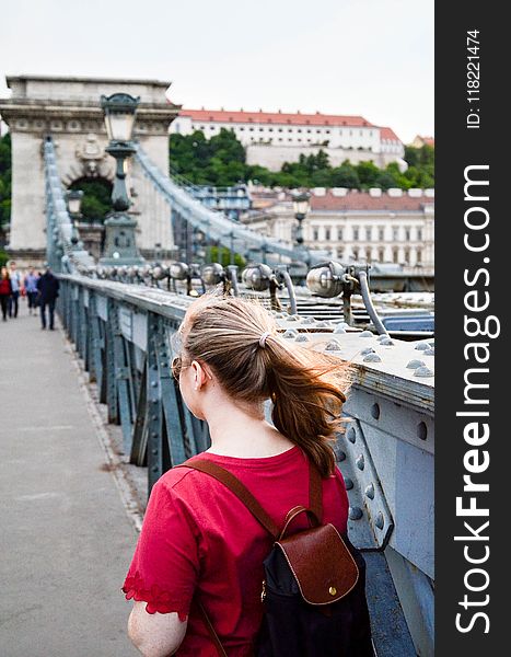 Woman Wearing Brown Leather Backpack Standing on Bridge Photo Taken