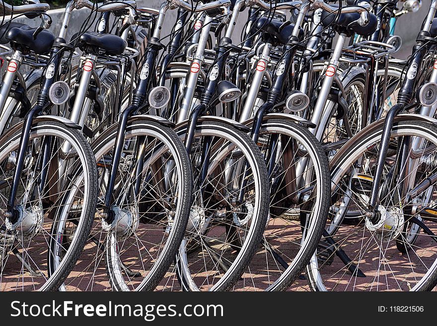 Gray And Black Bicycles Parked Near Gray Wall