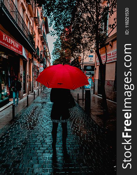 Photo of Person Holding Red Umbrella