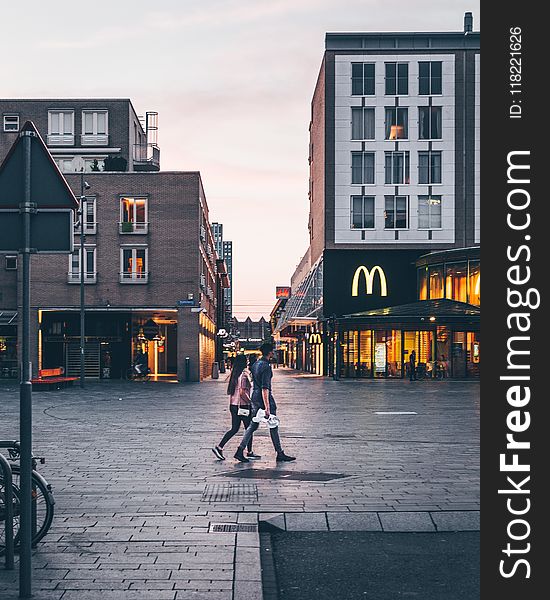 Man And Woman Walking On The Road