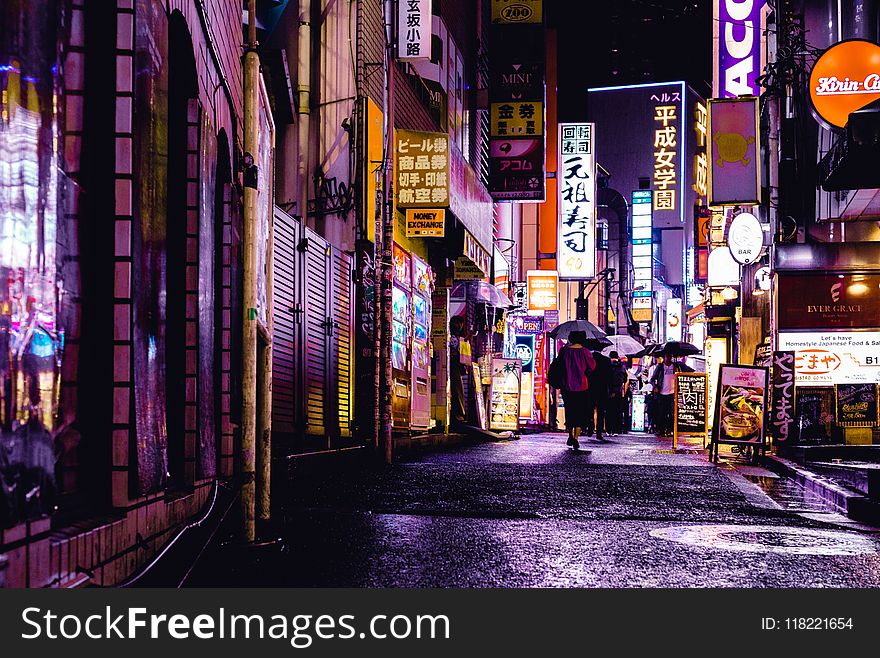 Woman Walking In The Street During Night Time