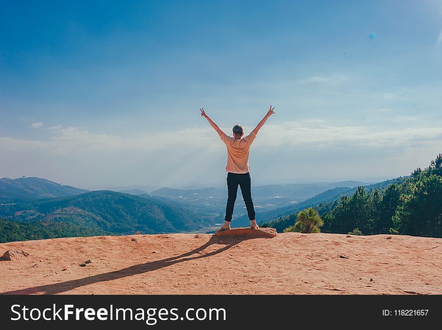 Woman Standing on Cliff