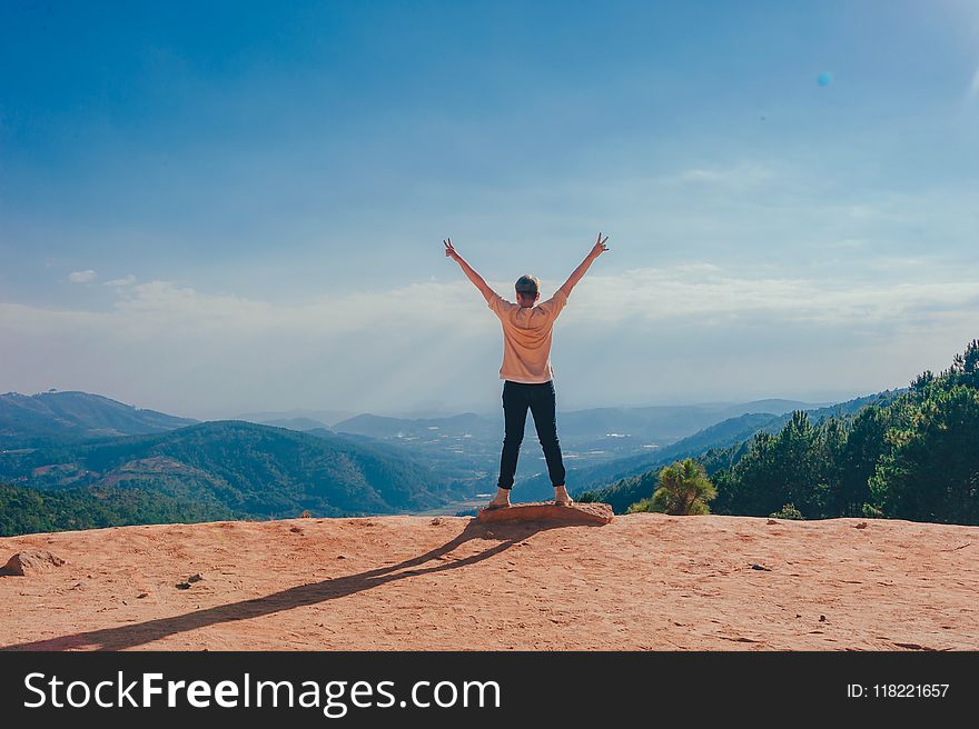 Woman Standing On Cliff