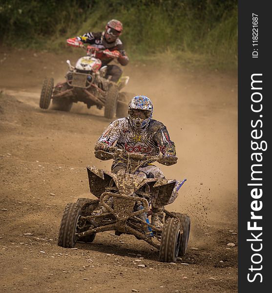 Man Wearing White Racing Outfit Stained With Mud Riding on Stained Mud Atv