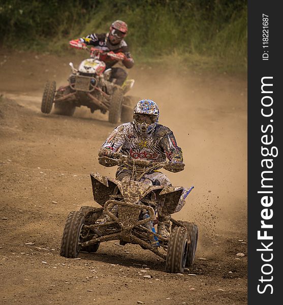 Man Wearing White Racing Outfit Stained With Mud Riding On Stained Mud Atv