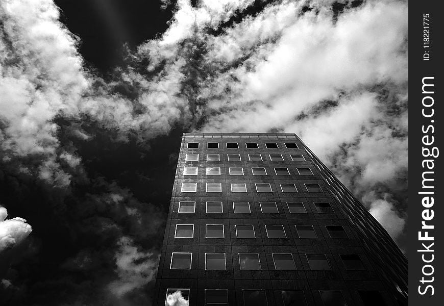 Low-angle Photography of Concrete High-rise Building Under Cloudy Skies