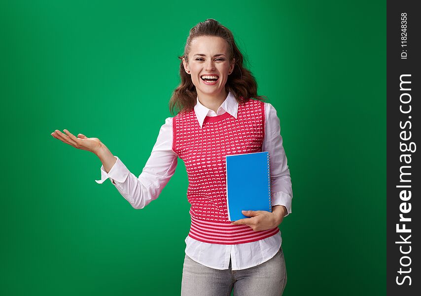 Student woman with blue notebook presenting something on empty